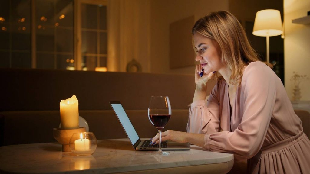 Lady doing work with a candle and a laptop - dato darren yaw