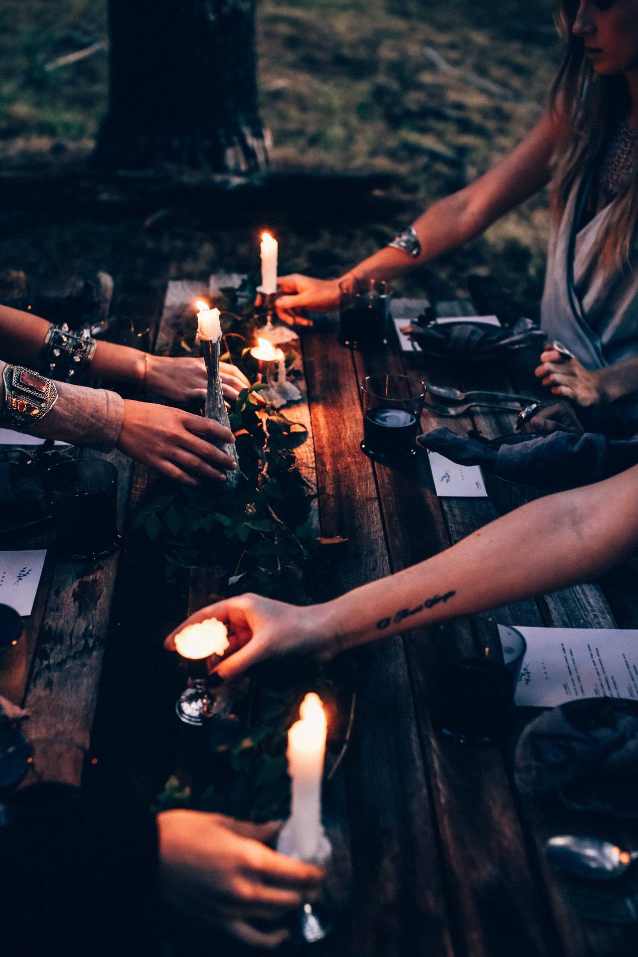 People arranging candles on a table - dato darren yaw