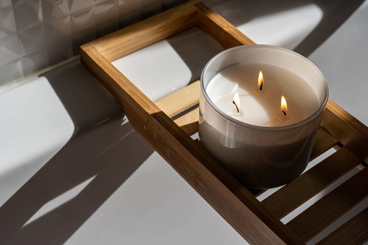 A candle on a wooden tray - Darren Yaw